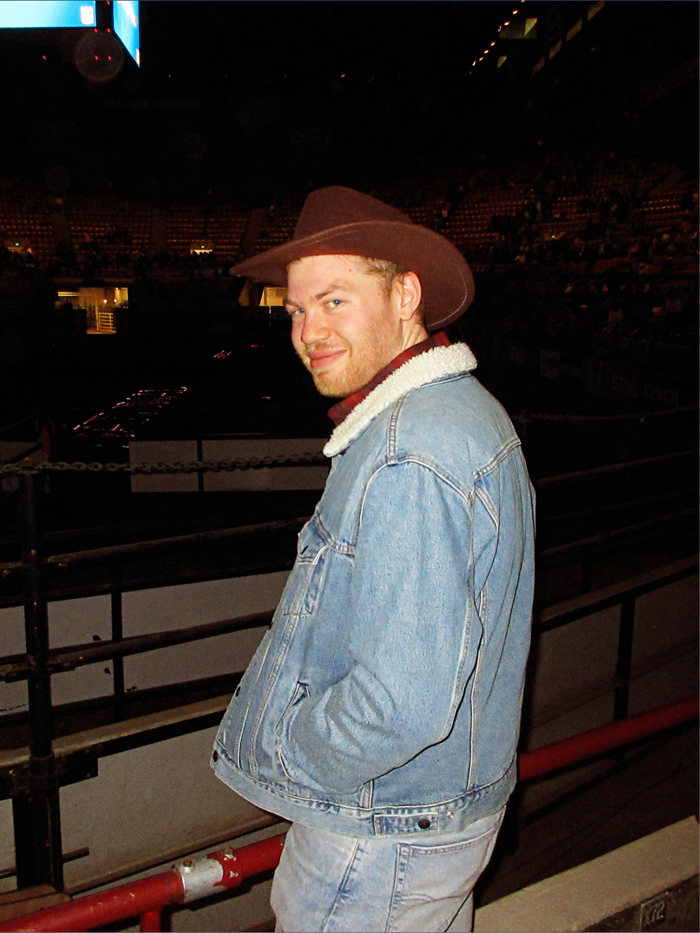 Andy Reed wearing a cowboy hat at a rodeo